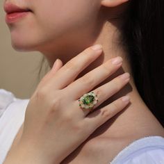 14K Solid Gold or Sterling Silver 1 Piece 10 x 14 mm Peridot｜Green｜Oval｜Eye Clean Peridot CTW: 7.50 10 Pieces 3 x 4 mm Opal｜Fire White｜Oval｜Eye Clean Opal CTW: 1.50 10 Pieces 2 mm Tsavorite｜Green｜Round｜Eye Clean Tsavorite CTW: 0.45 Ornament Measurements: 18 x 22 mm Total Item Weight (g): 6.50 Luxury Oval Tsavorite Jewelry, Oval Multi-stone Tsavorite Rings, Oval Tsavorite Multi-stone Ring, Oval Tsavorite Rings With Halo Setting, Oval Green Tsavorite Jewelry, Green Multi-stone Oval Cabochon Jewelry, Round Eyes, Green Oval, Peridot Green