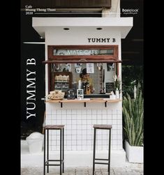 two stools sitting outside of a store front with the words yummy b on it