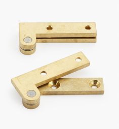 brass plated cabinet door hinges on white background