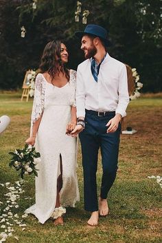 a man and woman standing next to each other holding hands