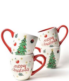 three cups with christmas designs on them sitting side by side in front of a white background