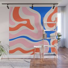 an orange, pink and blue wall mural in a living room