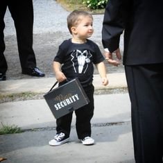 a little boy holding a sign that says security