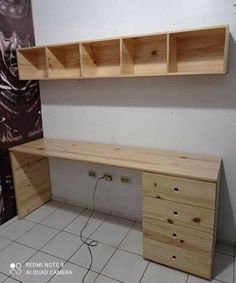 an empty room with two wooden shelves on the wall and a white tiled floor in front of it