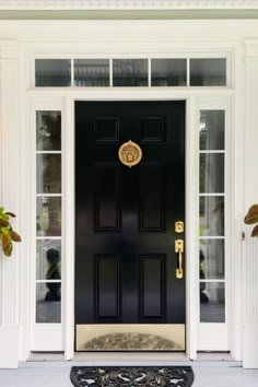 a black front door with gold accents