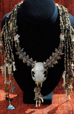 "Necklace Measurements: Neckline: 17\" Center piece: 2 1/2\" x 1 1/2\" Center Piece below Skull Head 4\" The front side strands also drape down the back for the waterfall effect with a backless dress. Waterfall: 12\" Interlocking Snake Vertebra, Squirrel bones, Antique Yoruba Lost Wax Gilded Brass Beads, Nigeria, Ethiopian Brass bicone beads.These are hand crafted beads made of an amalgamation of found metal- mostly brass but some other alloys like copper. They have a battered finish with somewh Totem Animal, Beach Jewelry Boho, Vintage Jewelry Ideas, Wire Wrapped Jewelry Diy, Bone Necklace, Bone Jewelry, Skull Head, Art To Wear, Pet Necklace