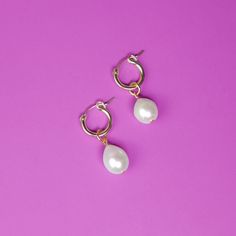 These dainty pearl drops are sublime! A must for your accessory closet, they can be worn every day or with glam formal wear and the like. Options include a teardrop-shaped glass pearl (perfect for everyday elegance), as well as a large freshwater pearl for a little more oomph! The charms hang from elegant 14k gold-filled hoops and are removable so you can wear the hoops on their own—two earrings in one! Try them with the 15mm hoops for a classic, every day look, or go for a more statement-making Everyday Pearl Drop Dangle Hoop Earrings, Everyday Hoop Earrings With Pearl Drop, Chic Small Hoop Earrings With Pearl Drop, Dainty Small Hoop Earrings With Pearl Drop, Pearl Teardrop Hoop Earrings With Pearl Drop, Everyday Dangle Teardrop Earrings With Pearl Drop, Everyday Pearl Drop Dangle Teardrop Earrings, Everyday Teardrop Dangle Earrings With Pearl Drop, Everyday Teardrop Earrings With Pearl Charm