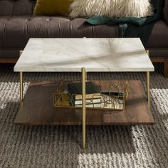 a living room with a couch, coffee table and pillows on the carpeted floor