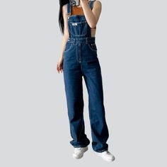 Step into the '90s with our dark wash distressed denim jumpsuit from the 2023 Spring-Summer Collection ââ‚?a modern take on aged style!Why It's Your Next Summer StapleThis ageless denim jumpsuit is the perfect blend of established fashion and edgy. aged style. With its straight leg silhouette and mid wash. this jumpsuit is patterned to flatter any figure while giving off that effortless cool. grunge look. The distressed pattern adds a unique touch. and the zipper and button closure ensure both t Casual Dark Wash Denim Overalls, Dark Wash High-rise Cotton Jumpsuits And Rompers, High Rise Dark Wash Cotton Jumpsuits And Rompers, High Rise Cotton Jumpsuits And Rompers In Dark Wash, Trendy High Waist Dark Wash Jumpsuits And Rompers, 90s Style Denim Overall Jumpsuit, 90s Denim Overall Jumpsuit, Dark Wash High Rise Relaxed Fit Jumpsuits And Rompers, High Rise Washed Denim Blue Jumpsuit