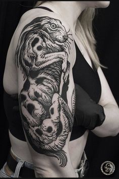 a woman with a dragon tattoo on her arm