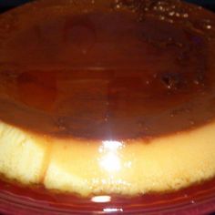 a cake covered in caramel sauce on top of a red plate