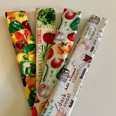 four different types of wrapping paper are lined up in a row on a white surface