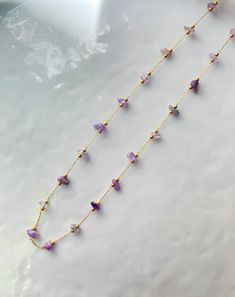 Beautiful string necklace handcrafted using the finest Amethyst agate stones. You can layer it up with any of our gold necklaces and style it your way. This necklace has adjustable length from 16 to 18 inches. Made with 18k gold plated brass metal. Dainty Natural Stone Choker Necklace, Gold Gemstone Beaded Lariat Necklace, Adjustable Gold-plated Gemstone Necklace, Dainty Adjustable Crystal Necklaces With Natural Stones, Adjustable Single Strand Amethyst Necklace, Gold Lariat Beaded Necklace With Gemstone, Gold Amethyst Single Strand Necklace, Gold Single Strand Long Crystal Necklace, Gold Long Crystal Necklace With Single Strand