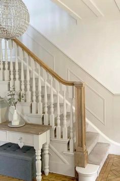 the stairs in this house have been painted white and are decorated with wood trimmings