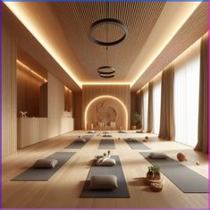 there is a yoga room with lots of mats on the floor and lights in the ceiling