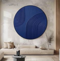 a living room filled with furniture and a large blue circular wall art above the couch