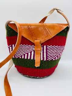 African Kenyan Handmade Traditional sisal tote kiondo handbag. Casual Beach bag Made from sisal Wool and leather handles. The bags are durable And unique. 100% made in Kenya. Measuring about  25cm wide x 19 cm H. The tote bag is lined inside with black lining. Weaved Bucket Bag For Market, Natural Woven Shoulder Bag, Weaving Bucket Bag For Travel, Natural Weaved Shoulder Bag, Natural Shoulder Bag With Weaving, Multicolor Handwoven Bucket Shoulder Bag, Everyday Weaving Bucket Bag, Eco-friendly Woven Travel Bag, Woven Shoulder Satchel For Market