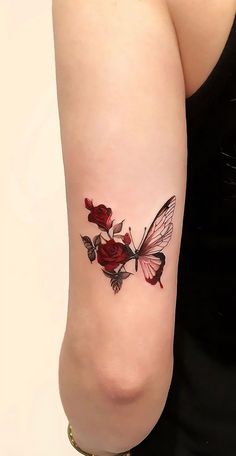 a woman with a tattoo on her arm has a rose and butterfly design on it