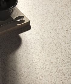 a kitchen counter top with utensils on it and a cup next to it