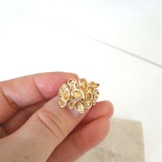 This is an absolutely amazing fancy statement gold ring. The ring is custom made and has a romantic touch into it. It is made of 10k solid yellow gold and weighs 5.5 grams. The size is 4.5 US. The ring features a gorgeous looking tropical flower where each petal is artistically crafted and different. The ends of each petal have a diamond cut, which makes the ring shine. The top of the ring measures 0.8 inches. The ring has a '10k' gold hallmark. The ring will definitely make a beautiful gift for any special occasion. The ring comes in a jewelry box and with a 'Thank you' card. If you are not satisfied with a ring, I will gladly accept a return. Contact me within 3 days of delivery and dispatch the item back within the next 3 work days. For more jewelry in my store visit: https://www.etsy.c Rose Gold Brass Wedding Ring, Formal Gold Flower Ring Stamped 14k, Yellow Gold Brass Rings For Anniversary, Gold Recycled Gold Rings For Gifts, Gold Rings Made Of Recycled Gold As A Gift, Gold Recycled Gold Ring Gift, Gift Gold Ring Made Of Recycled Gold, Fine Jewelry Brass Rings For Anniversary, 14k Gold Open Cluster Ring Gift