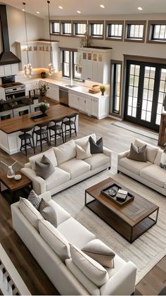 a living room filled with furniture and lots of windows