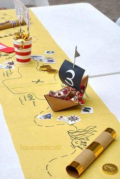 a table topped with lots of paper and crafting supplies on top of white tables