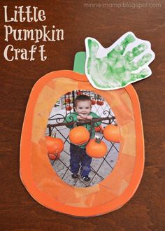 a little pumpkin craft with an orange and green paper cutout on the front, and a hand print in the middle