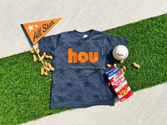 a t - shirt with the word hou on it next to peanuts and a baseball