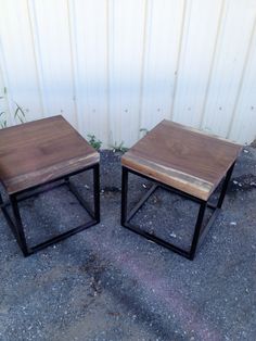 two wooden tables sitting next to each other on top of cement ground with grass in the background