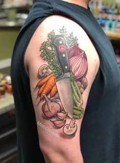 a man with a knife and vegetables tattoo on his arm