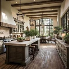 a large kitchen with an island and lots of counter space in front of the windows