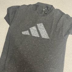 Grey Speckled T-Shirt Never Worn Casual Adidas Logo Top For Workout, Casual Workout Top With Adidas Logo, Casual Adidas Workout Top, Adidas Logo T-shirt For Workout, Crew Neck T-shirt With Three Stripes Branding For Workout, Crew Neck T-shirt With Three Stripes For Workout, Adidas Logo Crew Neck Workout T-shirt, Trendy Adidas T-shirt With Letter Print, Adidas Logo Workout T-shirt Crew Neck