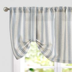 a window with blue and white striped curtains