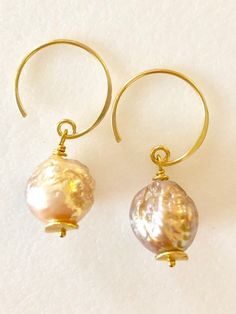 Soft peach glow Chinese freshwater Kasumi pearls wire wrapped on handmade  24k gold vermeil ear wiresBeautiful 11mm Chinese kasumi pearls with characteristic iridescent bumpy surface are full of color and texture and highly lustrous. They display a full array of metallic colors including dusty rose pink, peach and bronze. Stunning kasumi pearls are wire wrapped on 24k gold vermeil handmade ear wires with tiny gold vermeil wavy disc accents. Total length is 1 1/4”.  Also in Sterling silver. Briolette Pearl Earrings For Gift, Gold Briolette Pearl Earrings With High Luster, Handmade Pearl Jewelry For Celebrations, Handmade Teardrop Pearl Earrings, Unique Pearl Drop Jewelry, Handmade Baroque Pearl Jewelry, Briolette High Luster Pearl Earrings As Gift, Briolette High Luster Pearl Earrings For Gift, Gift Pearl Briolette Earrings