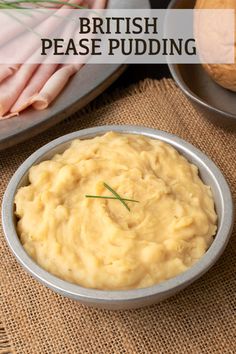 a bowl filled with mashed potatoes on top of a table next to other dishes