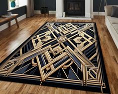 a living room with a large rug that has an art deco design on the floor