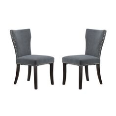 pair of grey velvet dining chairs with studded trimming on the back and legs