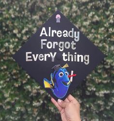 someone holding up a graduation cap with the words already forgot everything in front of them