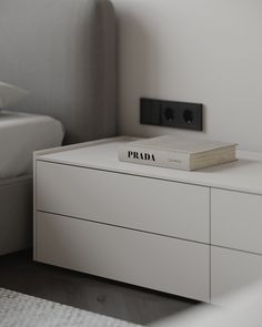 a book sitting on top of a white dresser