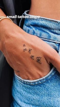 a woman's hand with butterflies tattooed on her left wrist and the word love written in