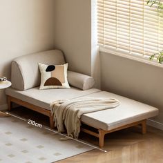 a day bed sitting in front of a window