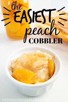 a white bowl filled with peach cobbler on top of a table