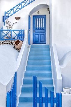 a blue and white staircase leading up to a door