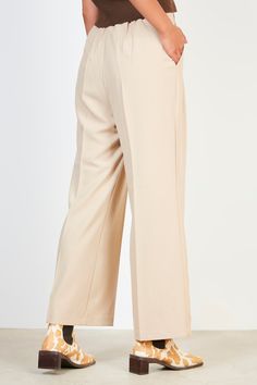 These beige pleated long trousers offer an understated look with cool sophistication. Enjoy the smooth fabric and impeccable tailoring that will make these trousers a staple in your wardrobe for years to come. - Extra long belt - Classic, timeless style - Quality fabric and impeccable tailoring Elegant Pleated Beige Pants, Belted Beige Trousers, Cream Wide-leg Pants With Pressed Crease, Wide Leg Cream Pants With Pressed Crease, Elegant Wide Leg Bottoms With Belted Cuffs, Elegant Full Length Belted Wide Leg Pants, Belted Beige Wide Leg Bottoms, Beige Belted Wide Leg Bottoms, Beige Wide Leg Belted Bottoms