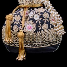 A perfect blend of Indian intricacy and Iranian design! This stunning pouch bag is dazzled with zardozi embroidery, sequins work and pearl moti with tassel finishing in the end. In-stock & ready-to-ship. *Please note, The placement of the embellishments may vary slightly as each bag is handmade and has unique qualities each time it is remade. We use faux stones and beads in all of our jewelry. Iranian Design, Evening Clutches, Zardozi Embroidery, Diwali Sale, Embroidered Handbag, Faux Stone, Classy Women, Pouch Bag, Hand Embroidered