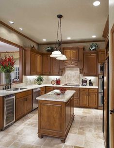 a large kitchen with wooden cabinets and marble counter tops, along with a center island