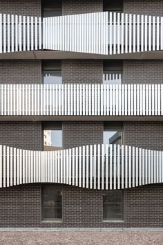 the facade of an apartment building with white balconies on it's sides