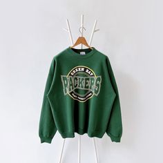 90s Green Bay Packers NFL sweatshirt/ XXL * PLEASE READ BEFORE PURCHASE * PLEASE consider the PHOTOS before making the decision * The images may DIFFER in appearance from the actual product because we took pictures under daylight.  * PLEASE send your PHONE NUMBER after your purchase for the shipping company to contact you X No returns X No refund Condition : 8/10 More details : mottled (front)/ faded color (back)/ look at the pictures  Brand : Hanes Size : XXL Pit to pit/ Chests : 27/54 inches Nfl Sweatshirt, Nfl Packers, Shipping Company, Cute Fits, Green Bay Packers, Green Bay, Phone Number, Sweat Shirt, Nfl