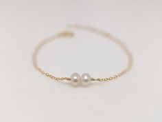 "Our gift to you 10% off your first purchase. Details here - http:/eepurl.com/dpVPBz You have found the perfect dainty pearl bracelet. Available with 1, 2 or 3 pearls. Personalize the number of pearls with your wishes, goals, children etc. Perfect for that special occasion yet simple enough for every day wear. You and your loved one will adore this meaningful gift. DETAILS 14 k fill or Sterling Silver. Choose 1, 2 or 3 pearls. Each fresh water pearl is unique, meaning the size and shape may vary Minimalist Adjustable Pearl Bracelet For Anniversary, Minimalist Pearl Bangle Jewelry, Minimalist Pearl Bangle Bracelet Gift, Minimalist Pearl Bracelet For Anniversary With Pearl Chain, Dainty Pearl Bracelets For Anniversary, Minimalist Pearl Bracelet For Anniversary, Delicate Pearl Chain Bracelet Gift, Delicate Pearl Chain Bracelet As Gift, Dainty Hypoallergenic Charm Bracelet For Weddings