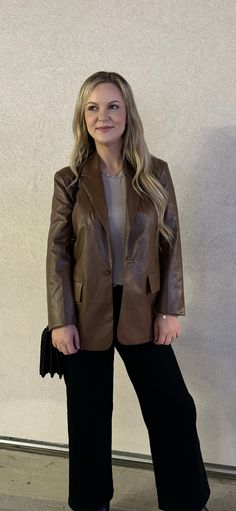 Out luxurious Cambridge Faux Leather Blazer is a must-have for any wardrobe. Crafted from brown faux leather, this blazer is both stylish and comfortable. It's the perfect addition to any outfit, whether you're heading to the office or on a night out. Runs slightly small. Model is wearing a Medium. Sleek Brown Leather Jacket For Fall, Sleek Brown Leather Outerwear, Fall Leather Jacket For Workwear, Winter Business Faux Leather Blazer, Elegant Brown Leather Jacket For Fall, Winter Formal Faux Leather Blazer, Brown Faux Leather Blazer For Office, Brown Fall Blazer For Night Out, Fall Formal Faux Leather Blazer